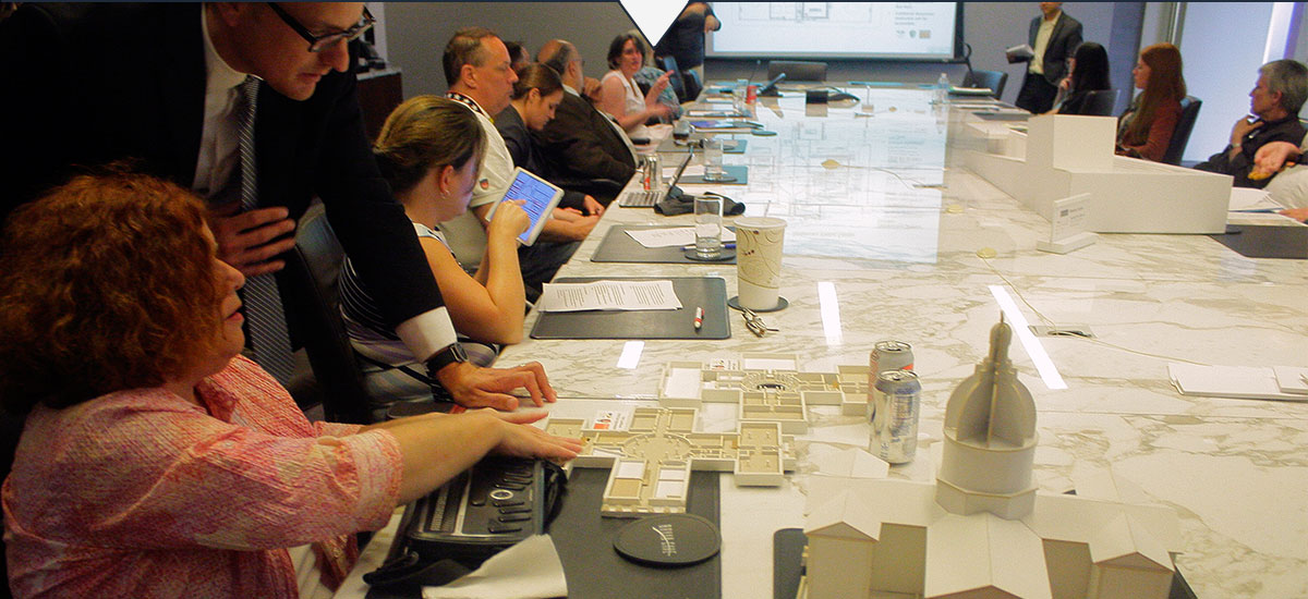 Photo of members of the City Arch River Universal Design Group reviewing designs using tactile models.