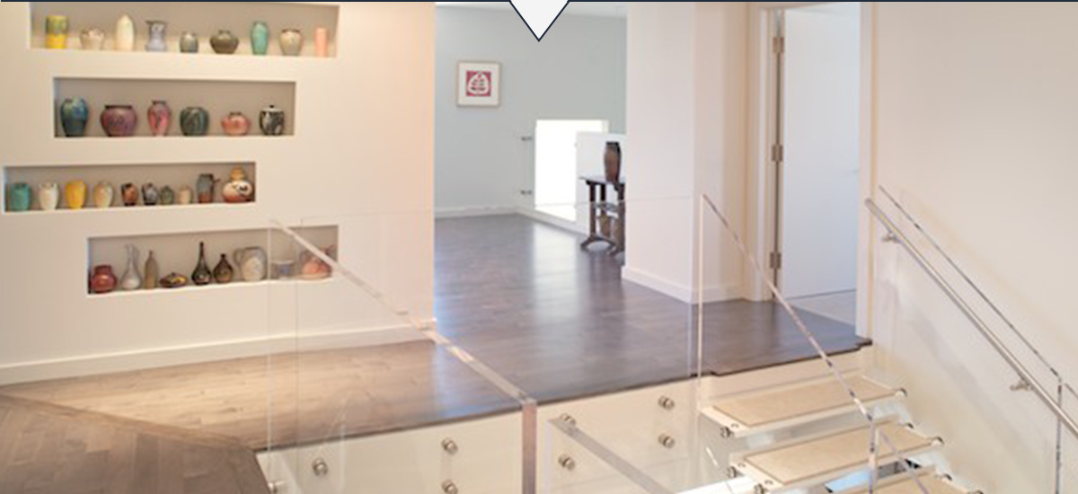 Photo of custom display nooks for ceramic art in private residence.